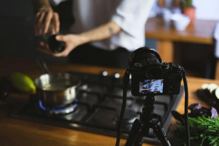 A culinary vlogger records their cooking process in a kitchen, showcasing a creative cooking setup.